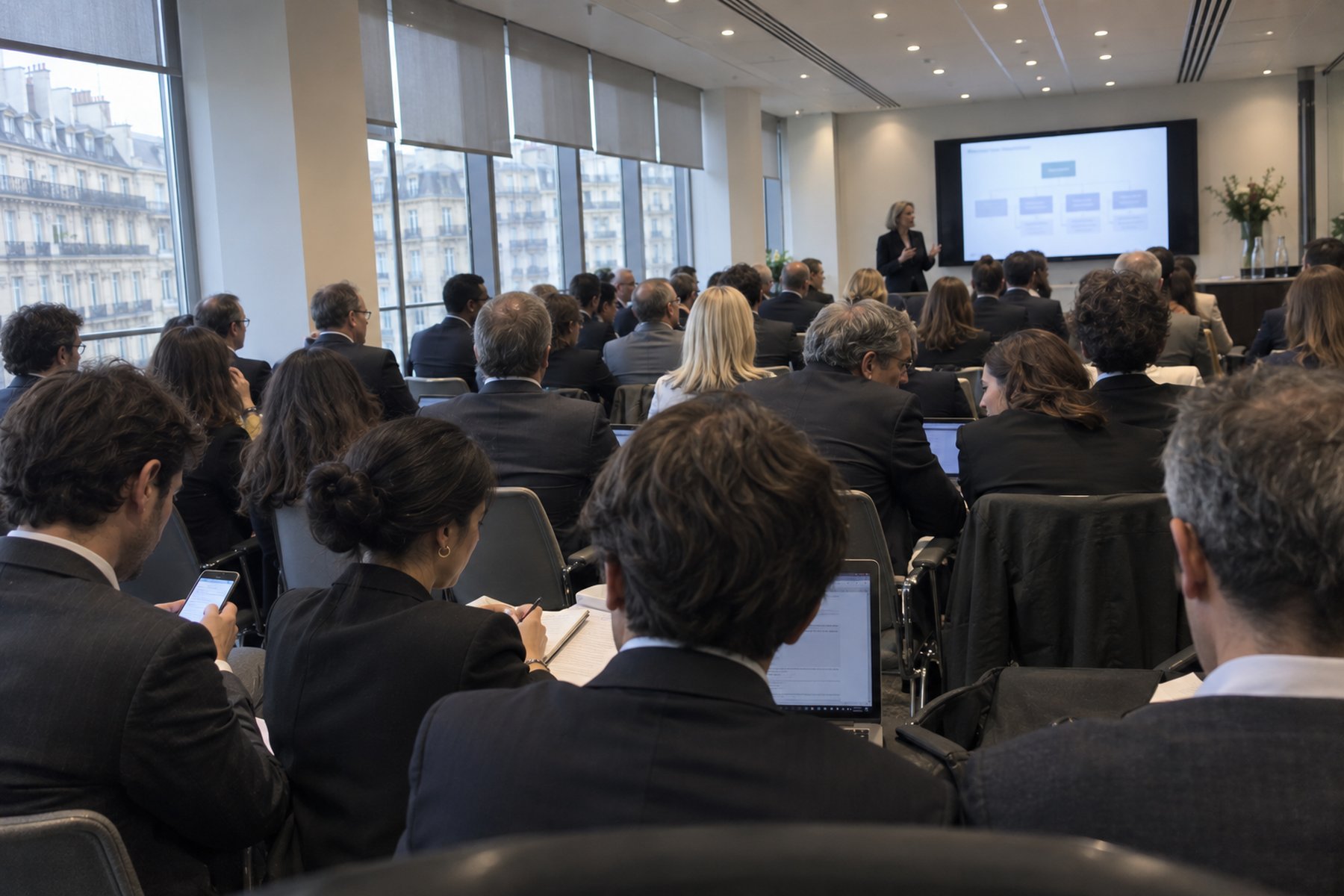 Internal meeting at a law firm: several dozen lawyers in plenary session